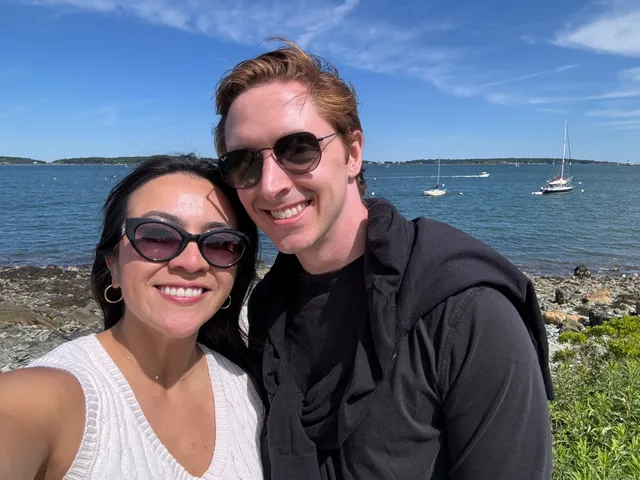 Mark and Vivian smiling together beside the water